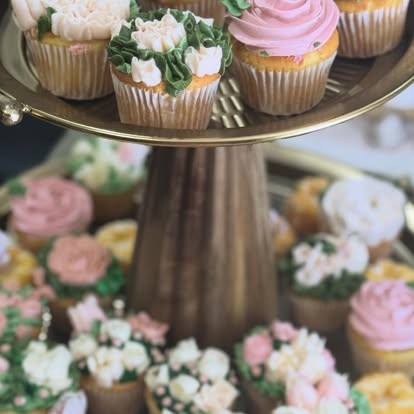 Tiered gold dessert stand with floral buttercream cupcakes